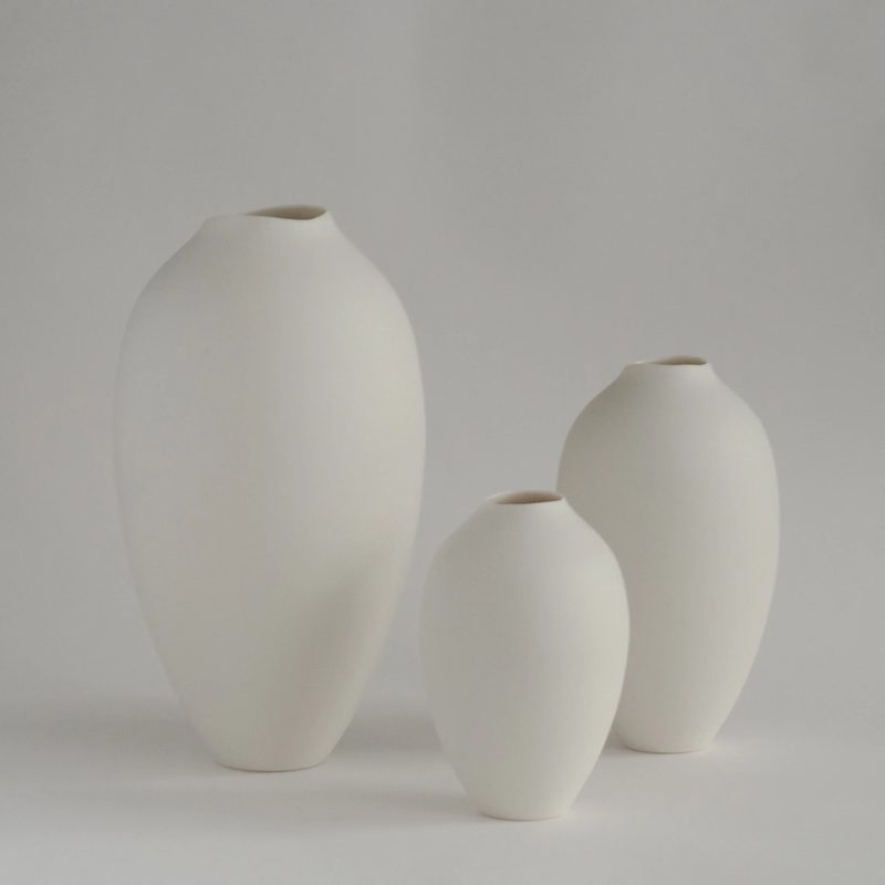 Two rounded porcelain vases on a light background
