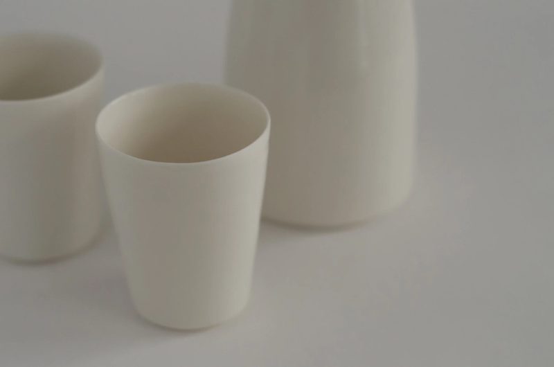 Two porcelain beakers, closely framed